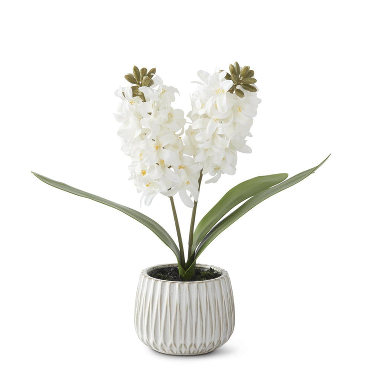 White ceramic pot holding a realistic white hyacinth plant with faux dirt in a 16-inch tall arrangement.