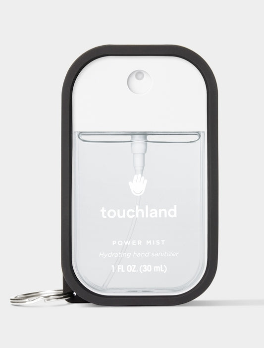 Jet Black rubber-silicone case with a metal keyring on a Touchland Power Mist hand sanitizer.