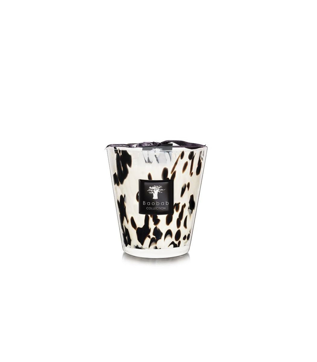 Baobab Collection Black Pearls candle in a white glass vessel with black spotted patterns.