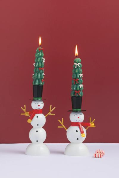 Two glossy white tin snowman taper candle holders with red scarves and black top hats.
