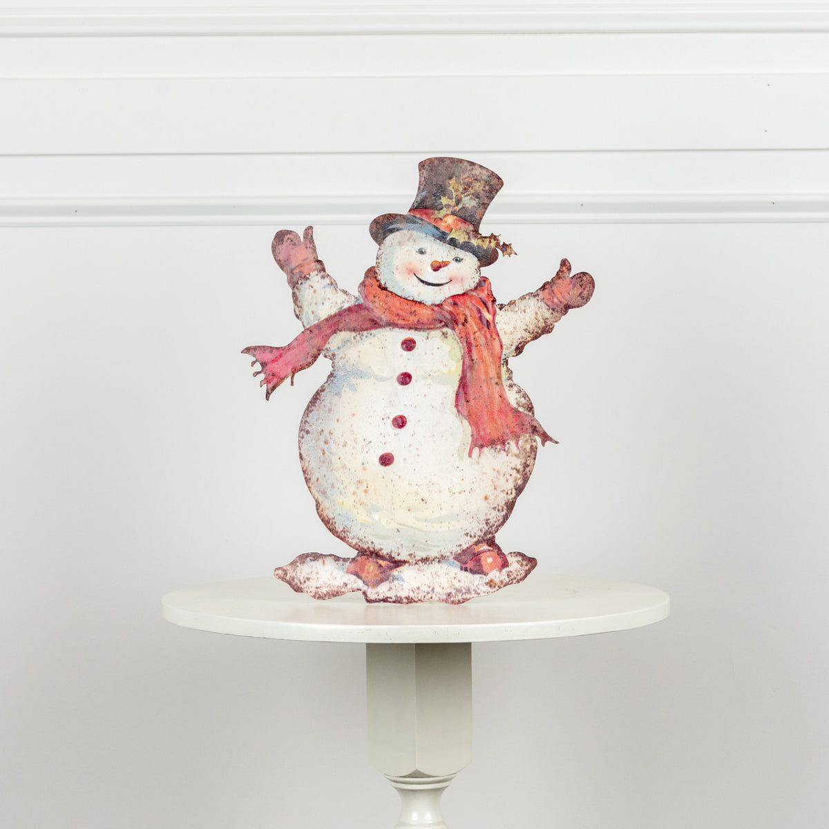Metal training dummy shaped like a happy snowman with black eyes and carrot nose.