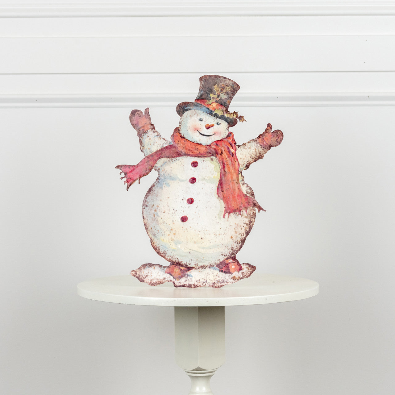 Metal training dummy shaped like a happy snowman with black eyes and carrot nose.