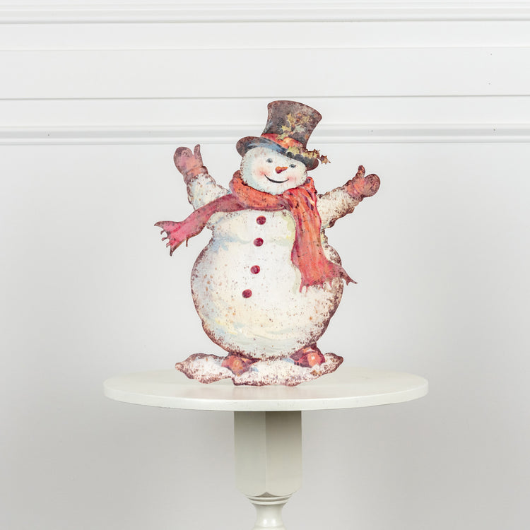 Metal training dummy shaped like a happy snowman with black eyes and carrot nose.