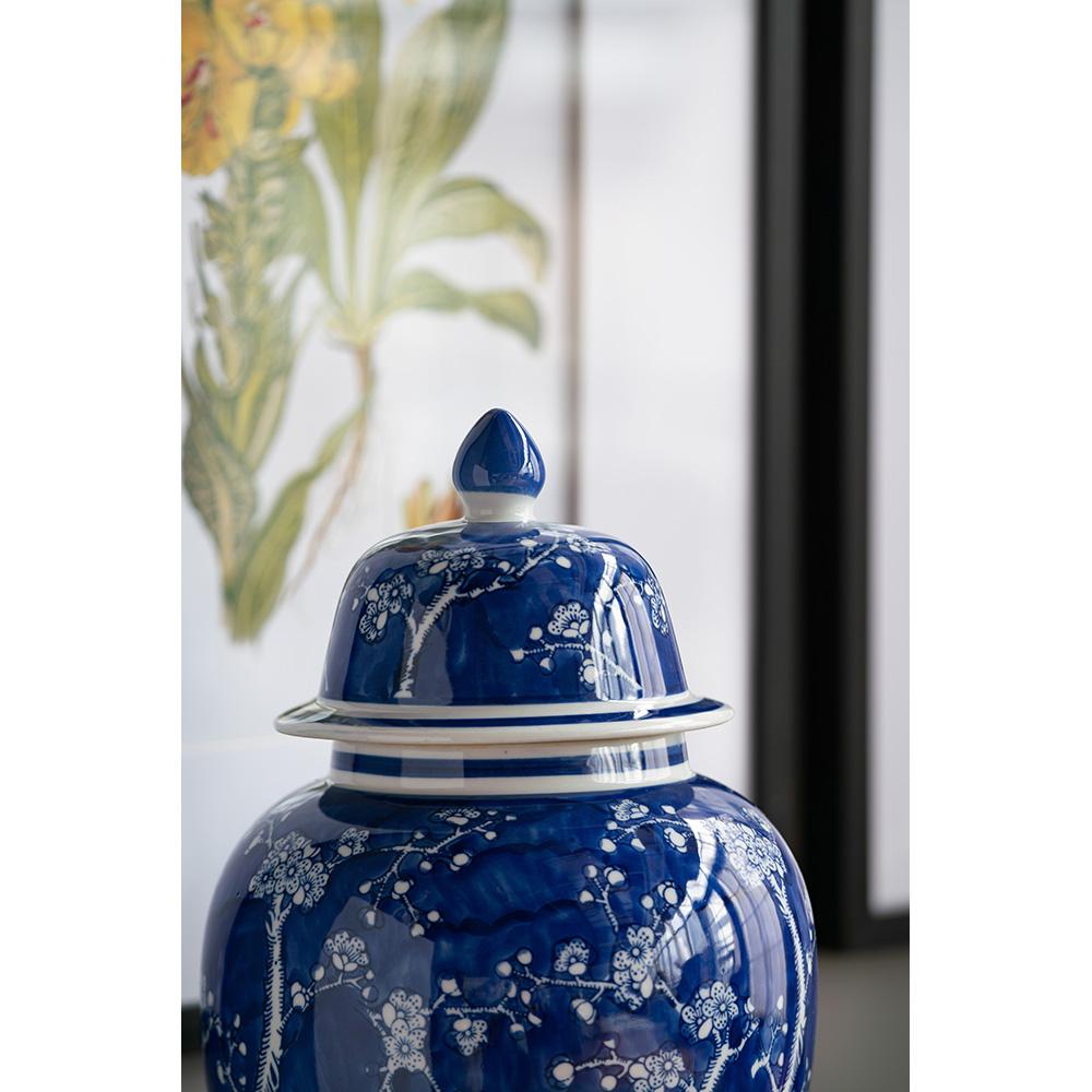 Small porcelain ginger jar with cherry blossom motif in pink floral pattern on white background