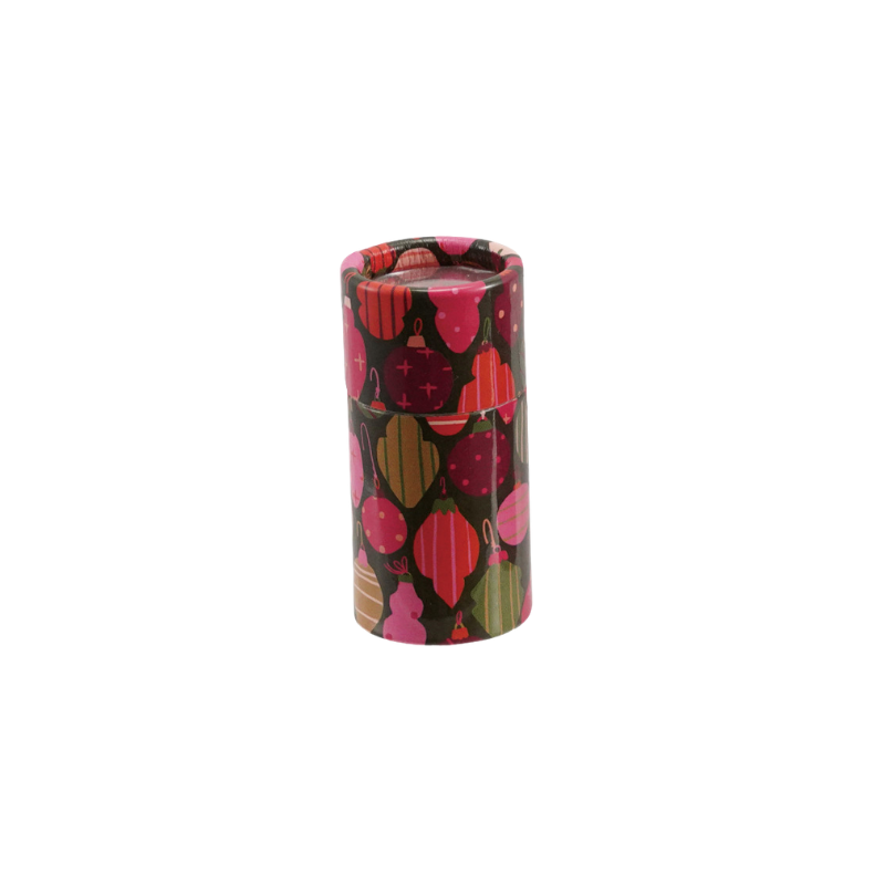 Safety matches in a small cylindrical tube featuring a colorful holiday ornament pattern.