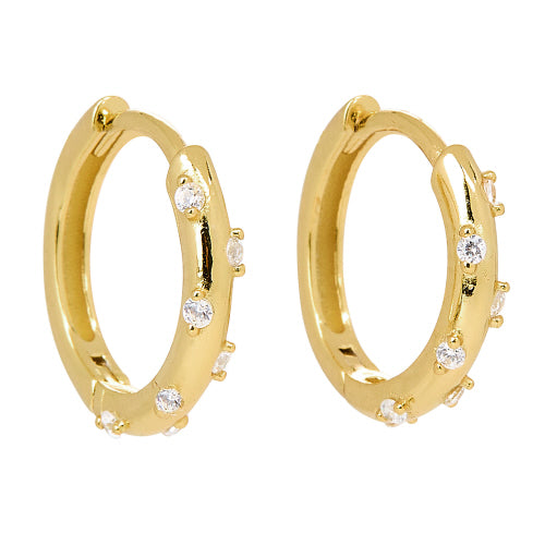 Gold huggie hoop earrings with small cubic zirconia stones dotted around the hoops.