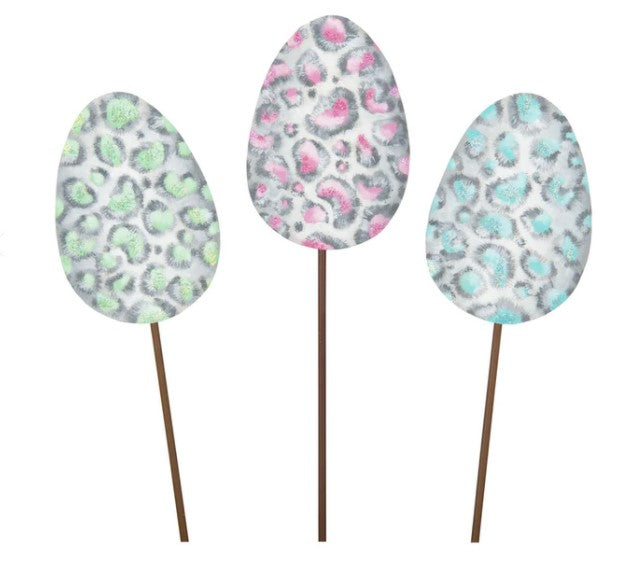 Pastel leopard egg-shaped candle with a soft spotted pattern.