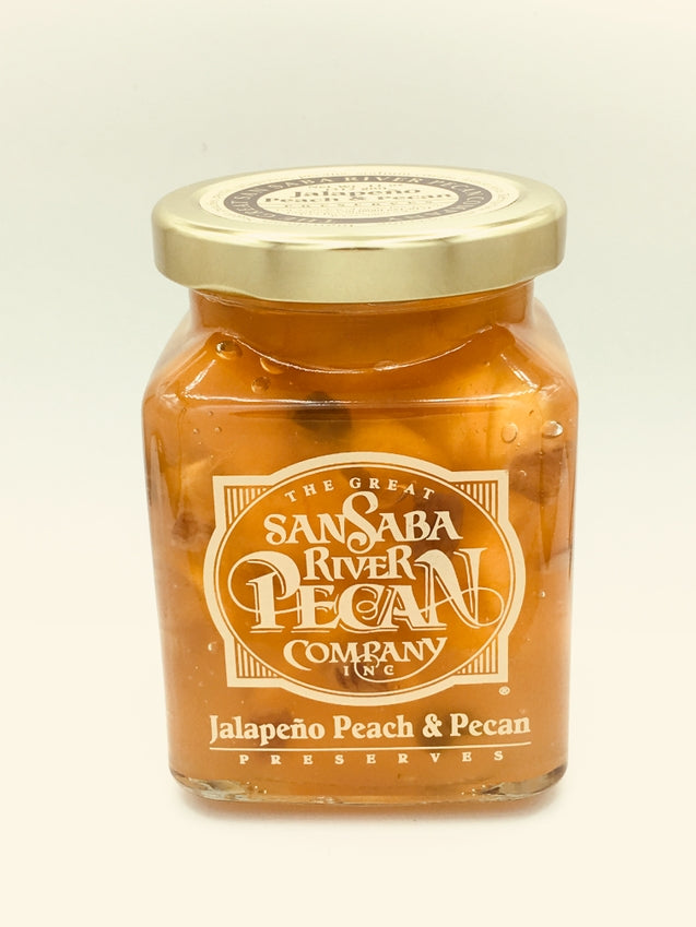 8 oz jar of San Saba River Pecan Company Jalapeño Peach & Pecan Preserves with a gold lid.
