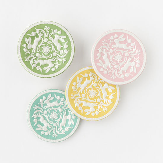 Ceramic embossed plate with an intricate raised texture on a neutral surface.