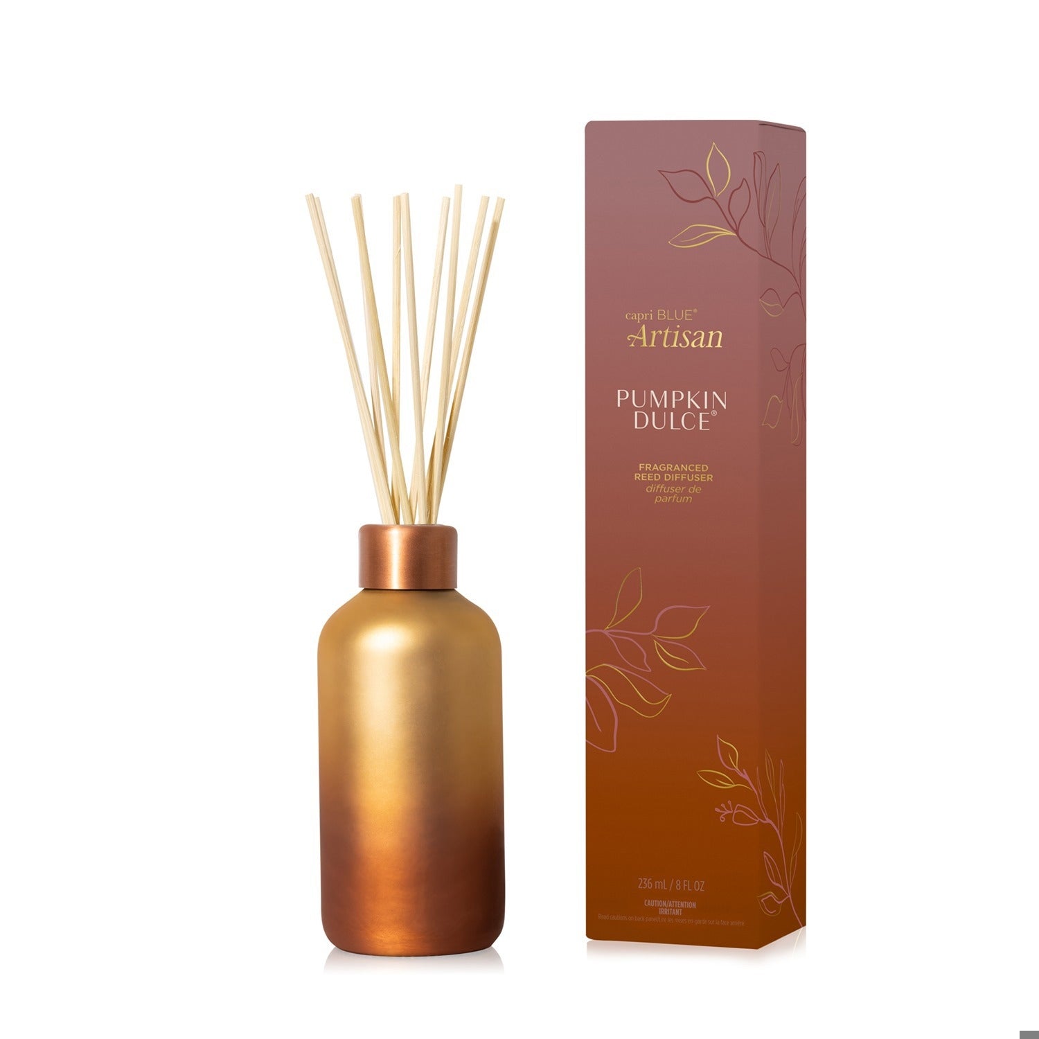 Capri Blue Pumpkin Dulce reed diffuser in a copper gradient glass bottle next to its matching box.
