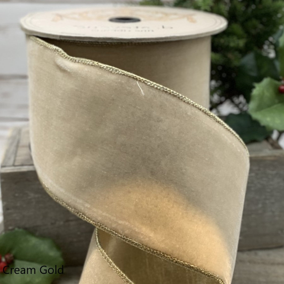1 inch wide cream gold lush velvet ribbon with metallic gold wired edges on a spool.
