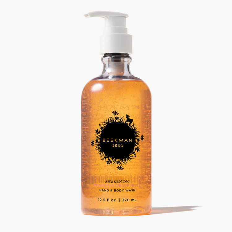 Beekman 1802 Awakening Honeyed Grapefruit Hand & Body Wash in a 12.5 fl. oz clear pump bottle.