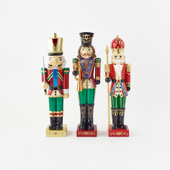 Resin nutcracker figurine with a lighted face feature.