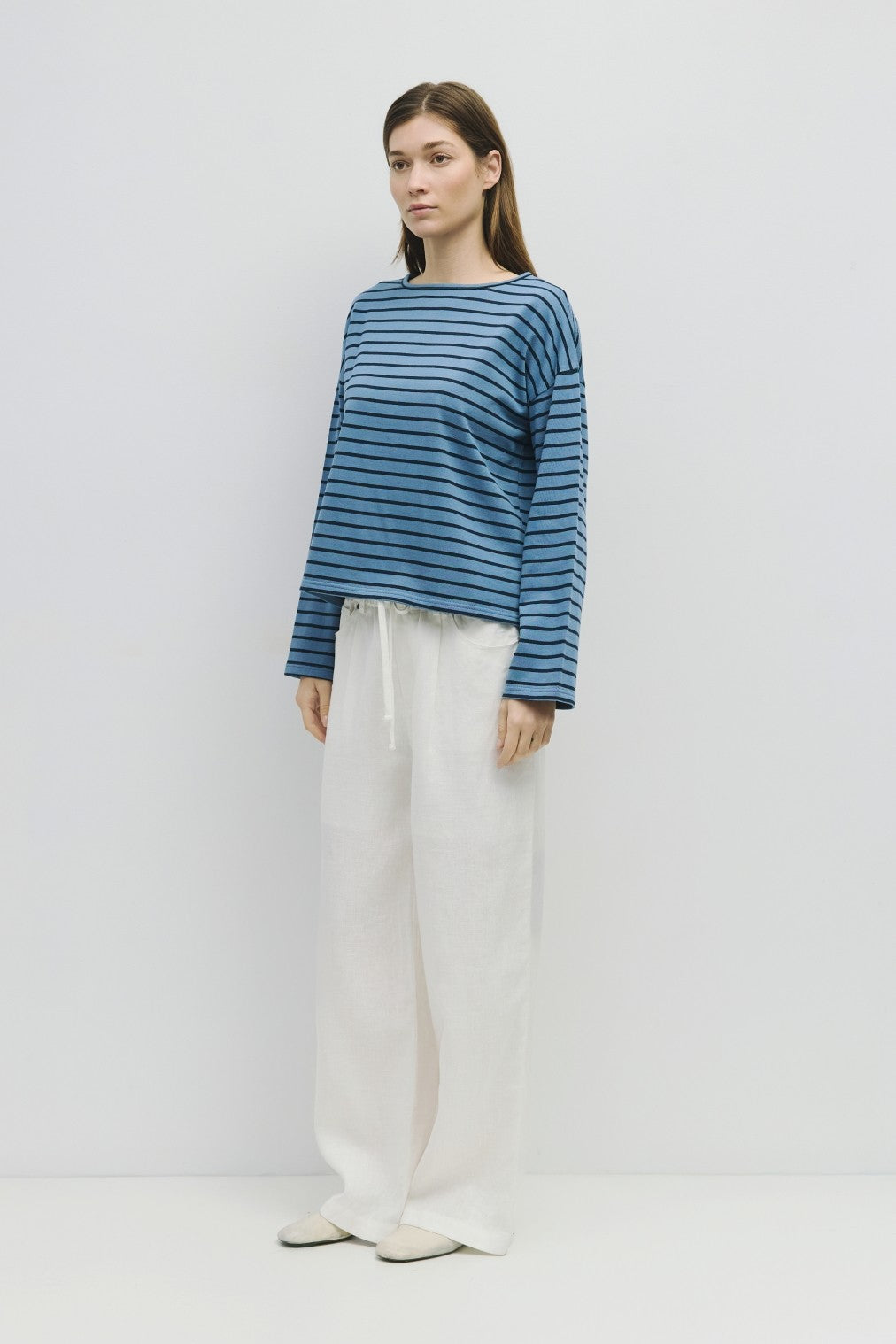 Nica The Moore Top in natural cotton with a relaxed silhouette featuring gathered detailing at the neckline and hem.