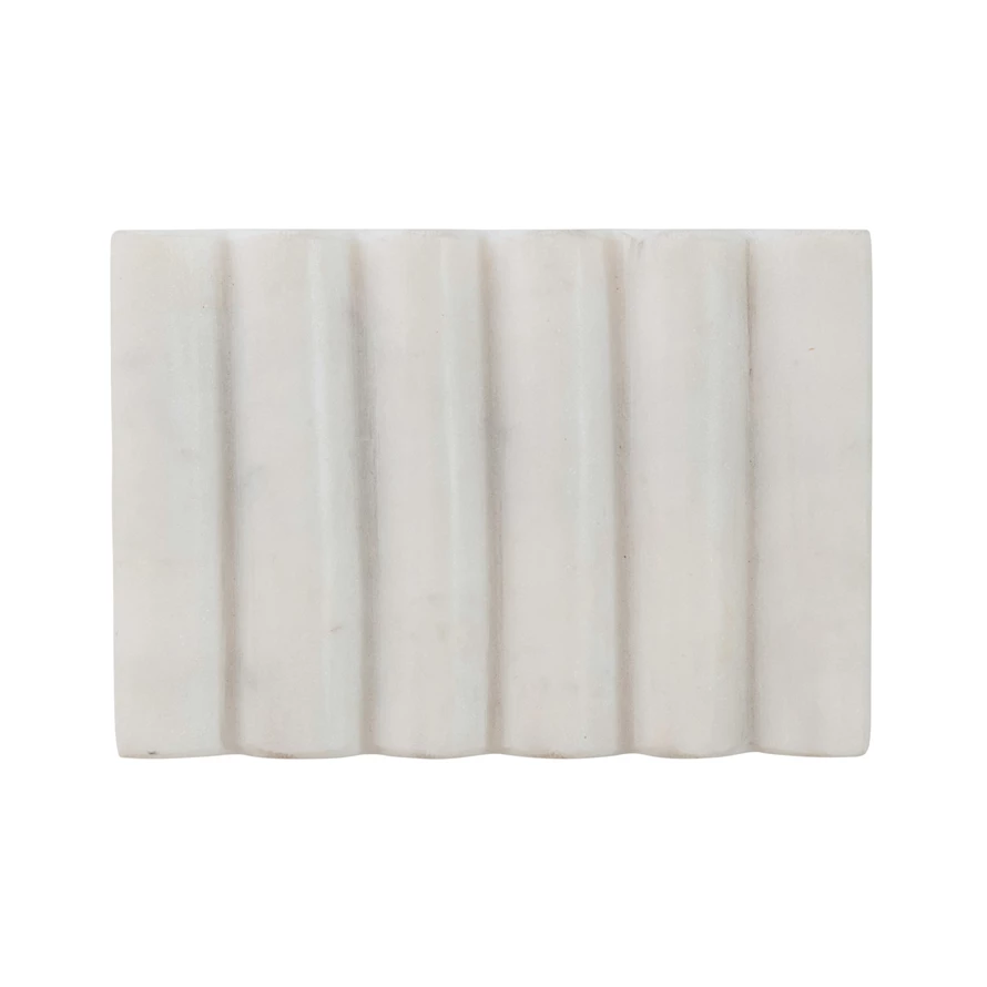Rectangular white carved marble soap dish with a vertical grooved design for drainage.