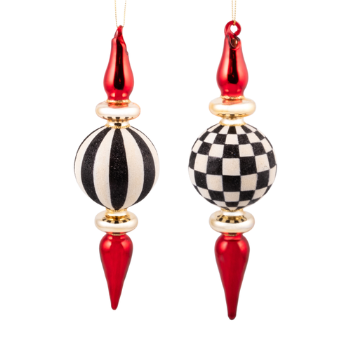 Black and white glass finial ornaments with red and gold accents in striped and checkered patterns.