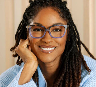Woman wearing Athens square blue light glasses with a purple and grey tortoiseshell frame.