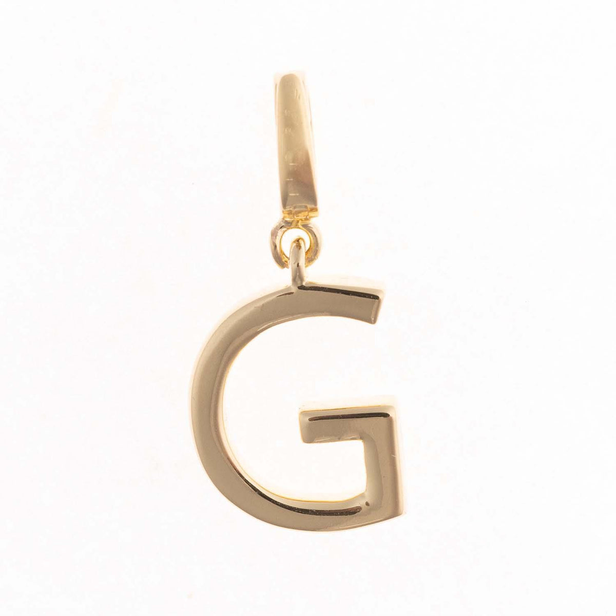 18k gold plated Tia initial charm featuring the letter G with a clasp for attaching to a chain.