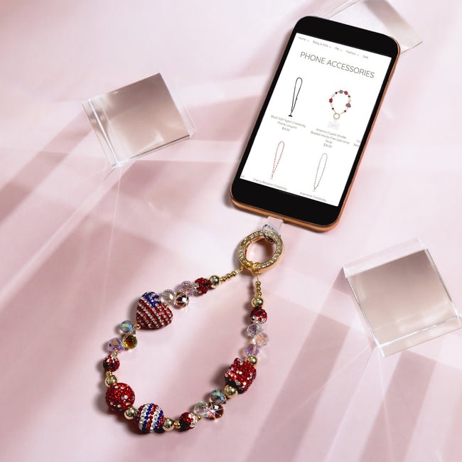 America Crystal Wristlet with red, white, and blue beads attached to a smartphone.