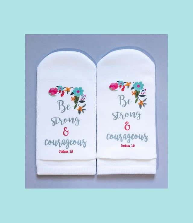 No-show women's socks with a floral print on the leg and Joshua 1:9 verse text printed in black on the sole.