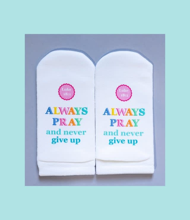 White women's no-show sock with black block text reading 'Standing on the Word' and verse Luke 18:1.