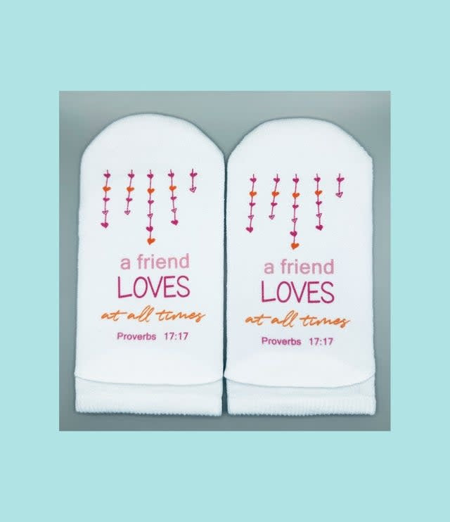 White women's no-show sock with heart strand design on the leg and Proverbs 17:17 verse printed on the sole.