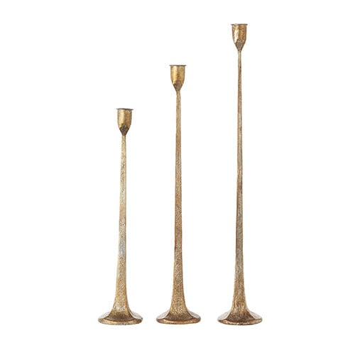 Three gold iron candlestick holders in small, medium, and large sizes designed for taper candles.