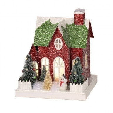 7.5-inch red and green glittered cardboard village house with LED lights, trees, and a snowman.