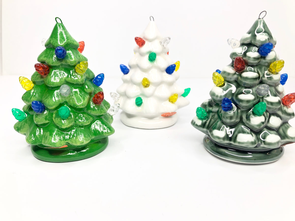 Mini ceramic tree with a small light-up feature in neutral tones.