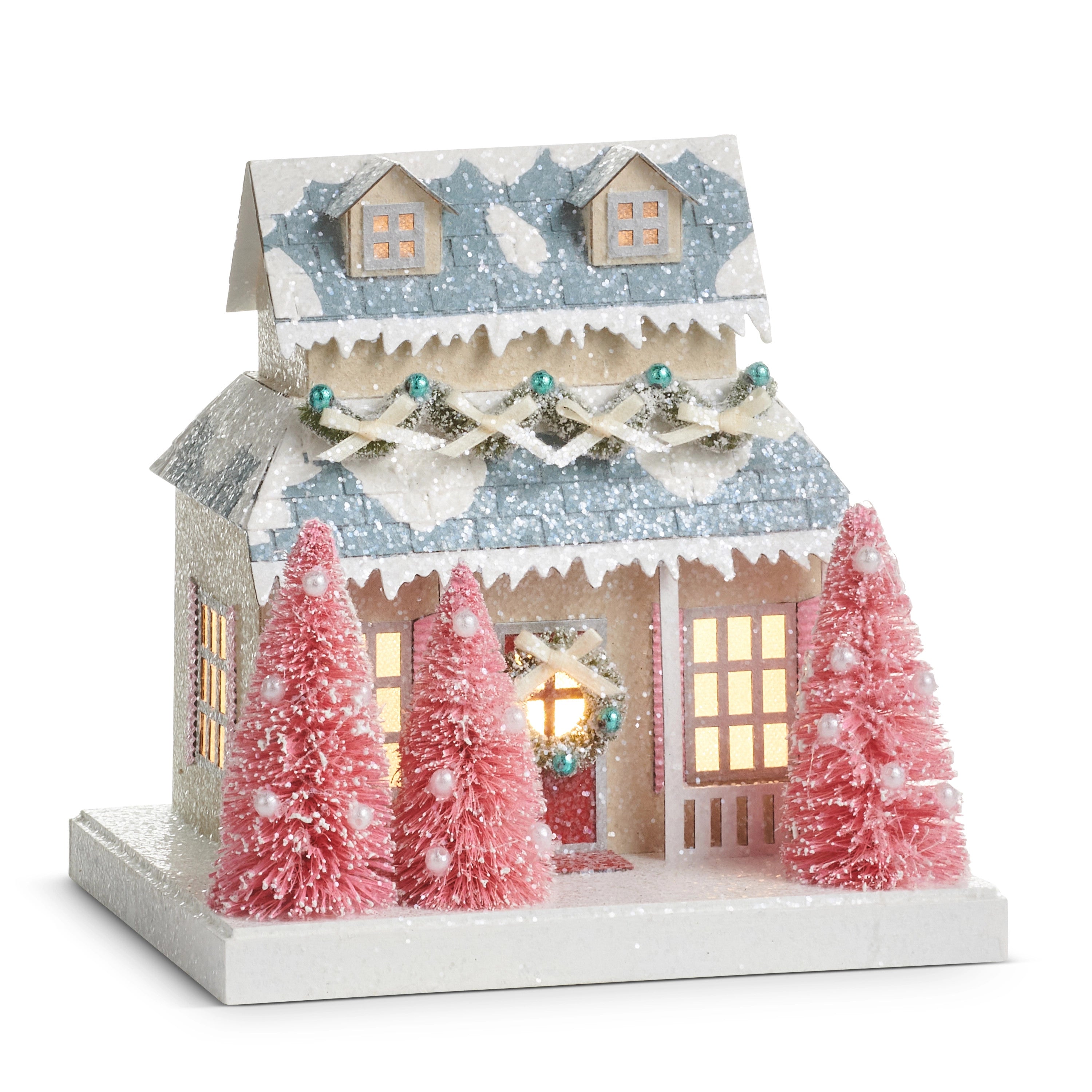 7.75-inch lighted paper cottage with blue glitter roof, pink sisal trees, and warm glowing windows.