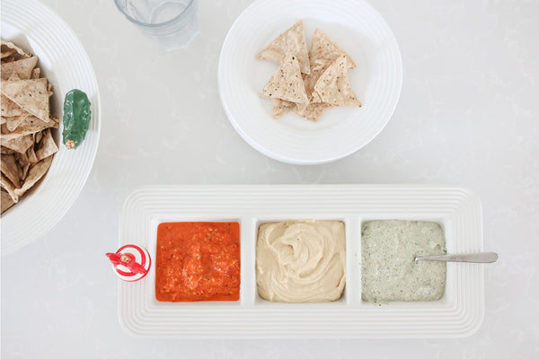 White ceramic Garnish Dish Stripes with three compartments holding red, tan, and green dips.