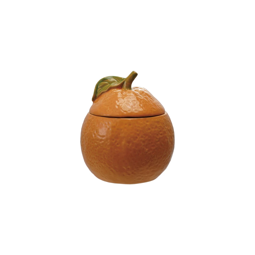 Stoneware orange jar with green lid; round shape.