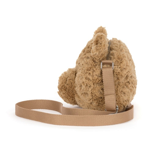 Side view of the Bartholomew Bear Shoulder Bag in honey brown fur with a long fabric strap.