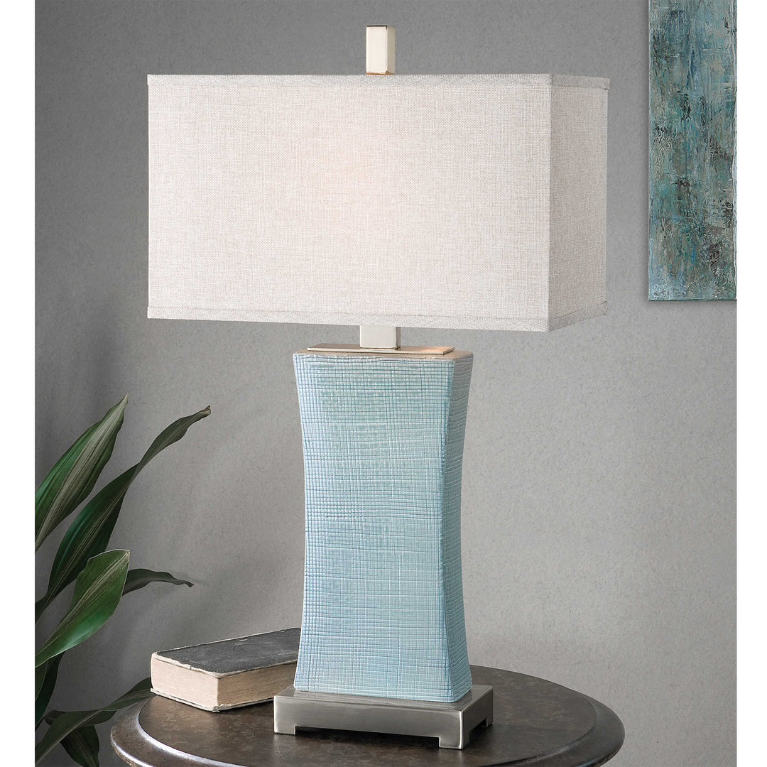 Cantarana table lamp with a cylindrical shade in neutral tone.