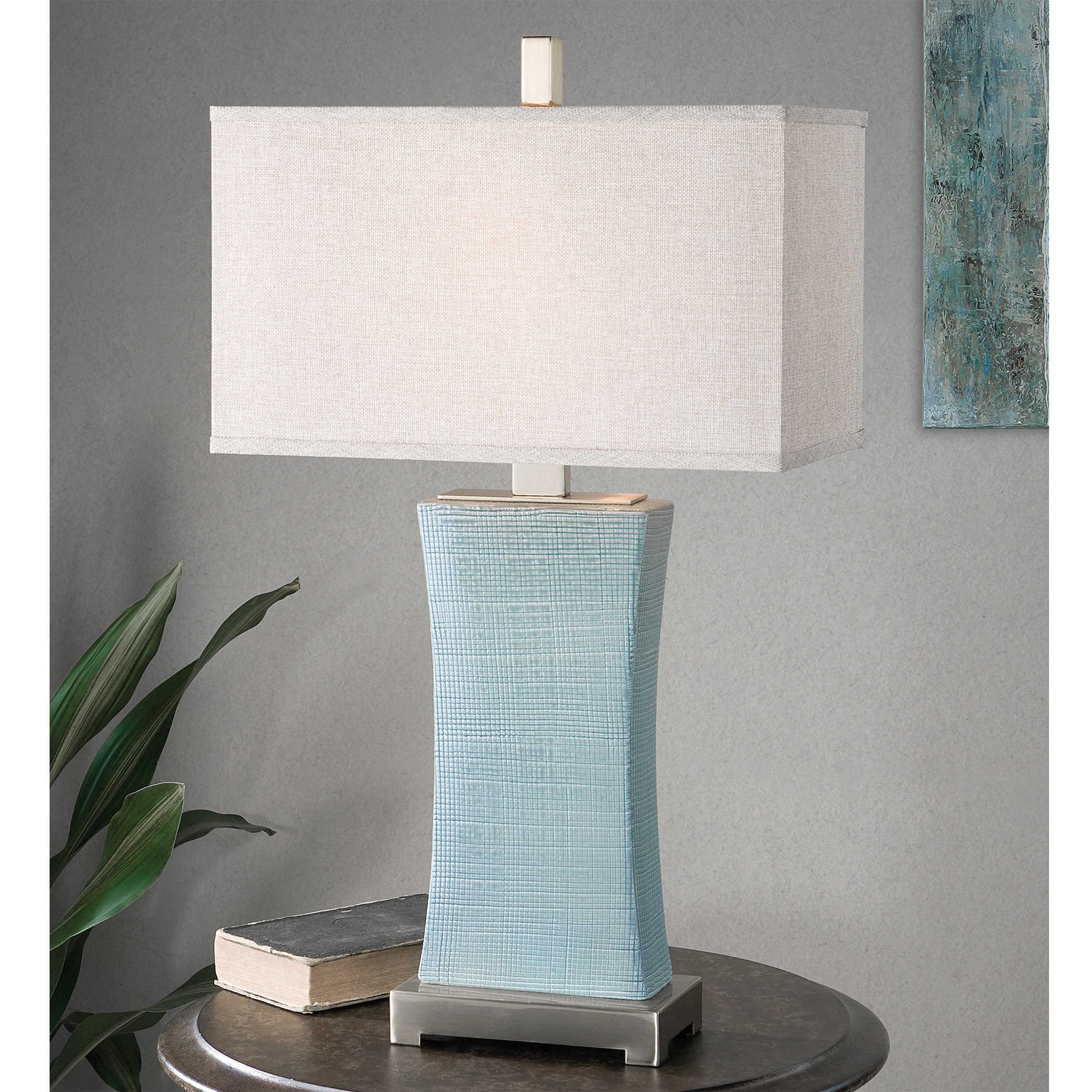Cantarana table lamp with a cylindrical shade in neutral tone.