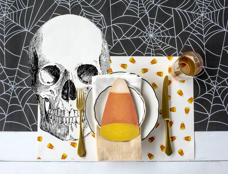 Candy corn themed placemat with orange yellow white striped triangular pattern on beige background.