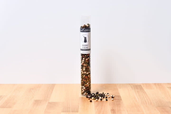 Four-peppercorn blend jar containing black, white, green, and pink peppercorns.