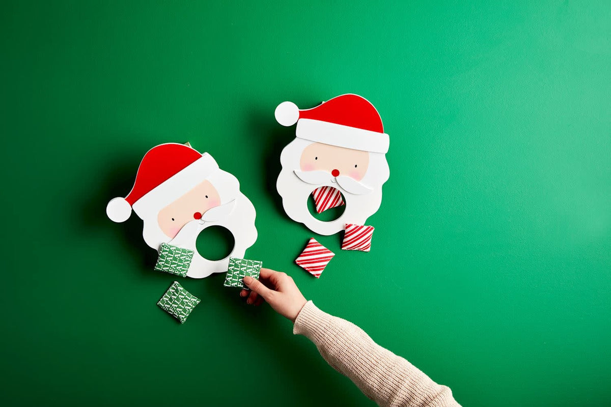 Wooden Santa bag toss game with two pine goals and six bean bags.