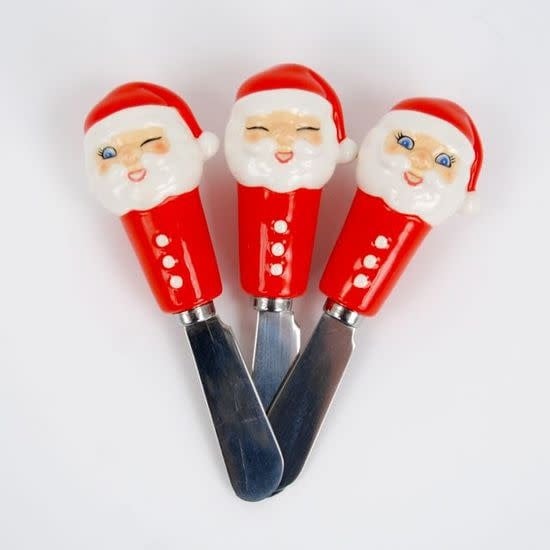 Ceramic Santa Spreader figurine with red suit, white beard, black boots, and green hat.