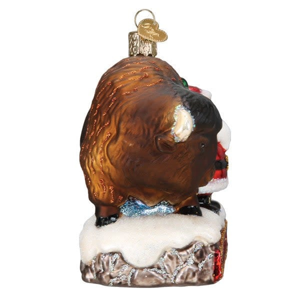 Glass Santa with bison ornament featuring silver interior, hand-painted colors, glitter accents, and a festive silhouette.