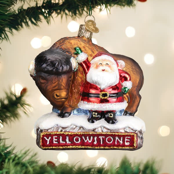 Glass ornament featuring a Santa Claus figure riding a bison with silver interior finish