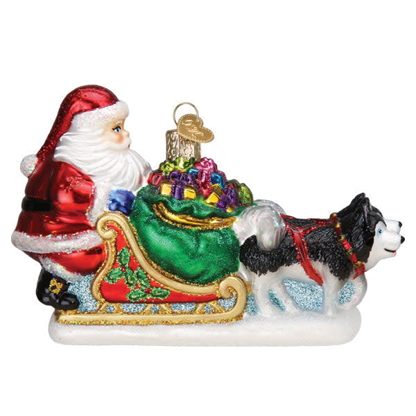 Red plastic Santa's dog sled ornament featuring a team of brown dogs pulling the sleigh with white accents.