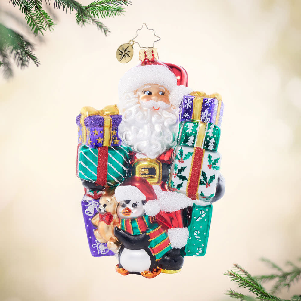 Santa's Shopping Shenanigans ornament: red glossy plastic Santa figure holding a shopping bag with white trim.
