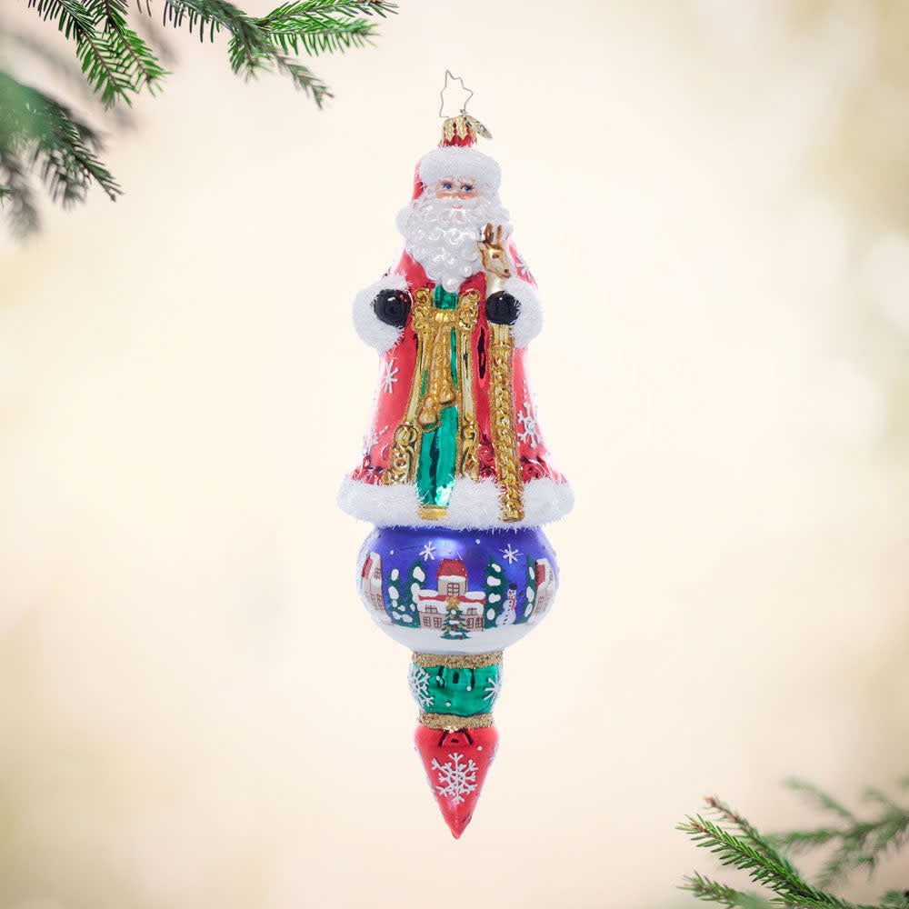 Santa's Splendid Snowscape ceramic ornament featuring a snowy winter village scene with red and white colors.