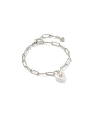 Silver heart-shaped freshwater pearl charm with a beauty mark on a delicate paperclip chain bracelet.