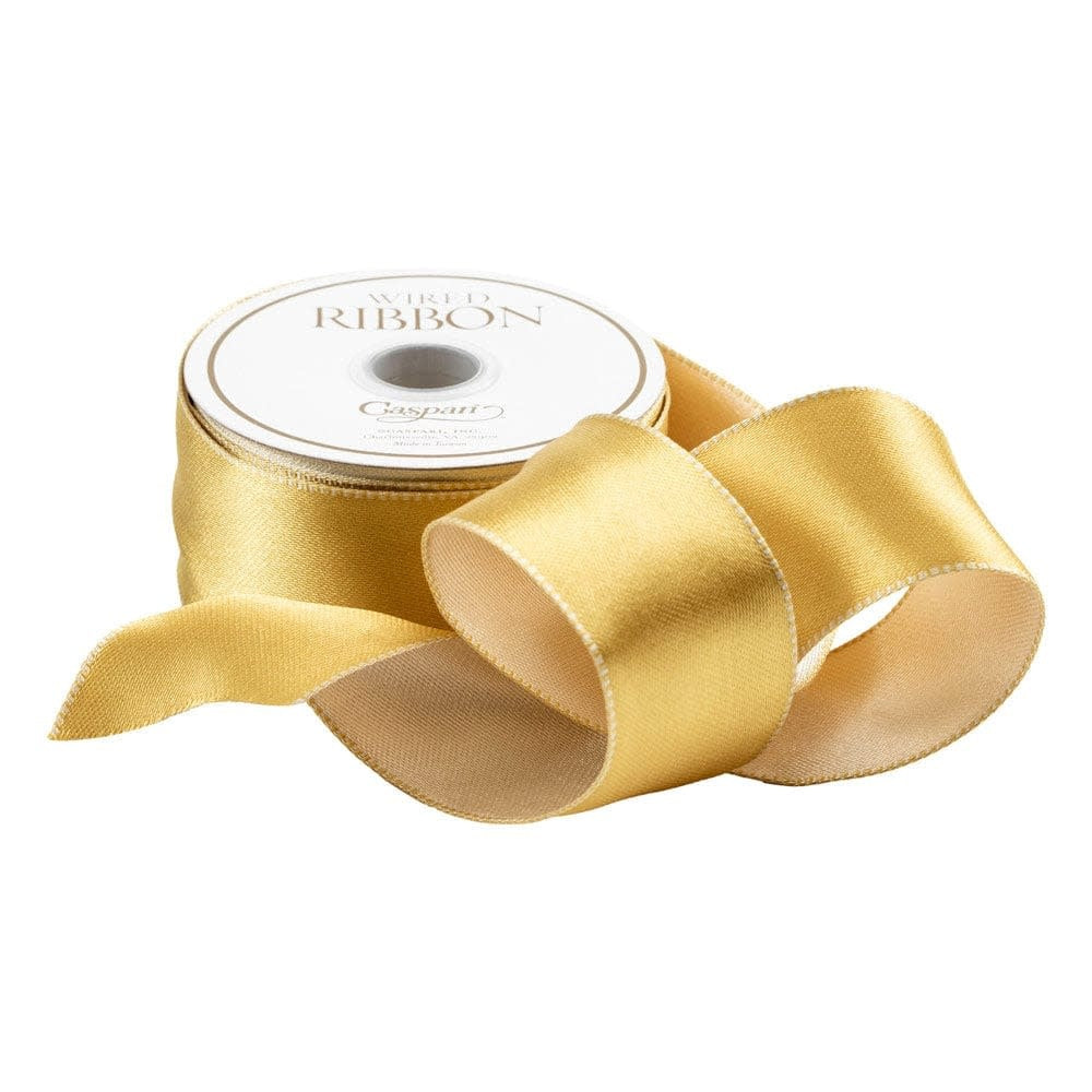 Spool of satin ivory and gold reversible wired ribbon with a smooth finish.