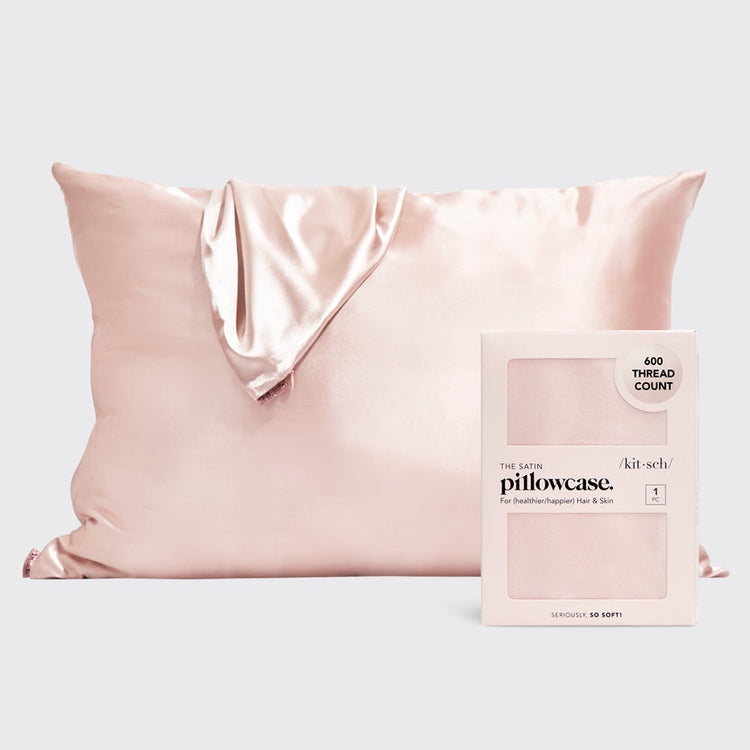 Blush satin pillowcase with smooth texture designed to reduce frizz and prevent facial creases.