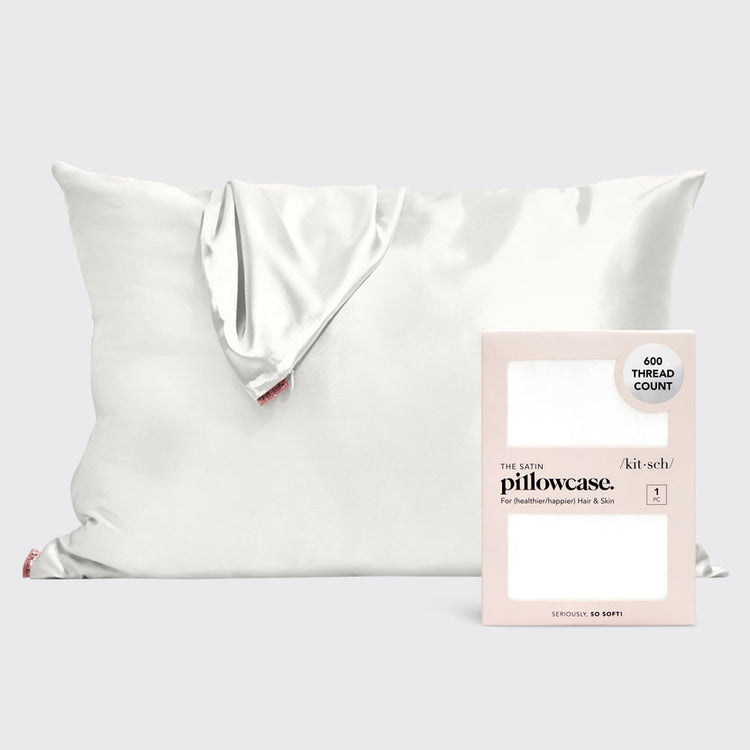 Ivory satin pillowcase with smooth texture designed to reduce frizz and prevent facial creases.