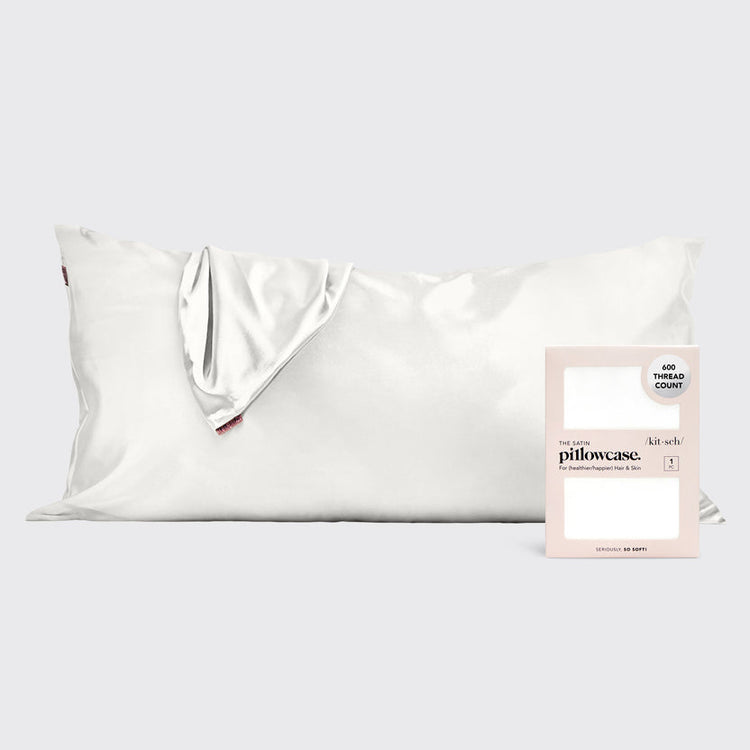 Ivory satin pillowcase with smooth texture designed to reduce frizz and prevent facial creases.