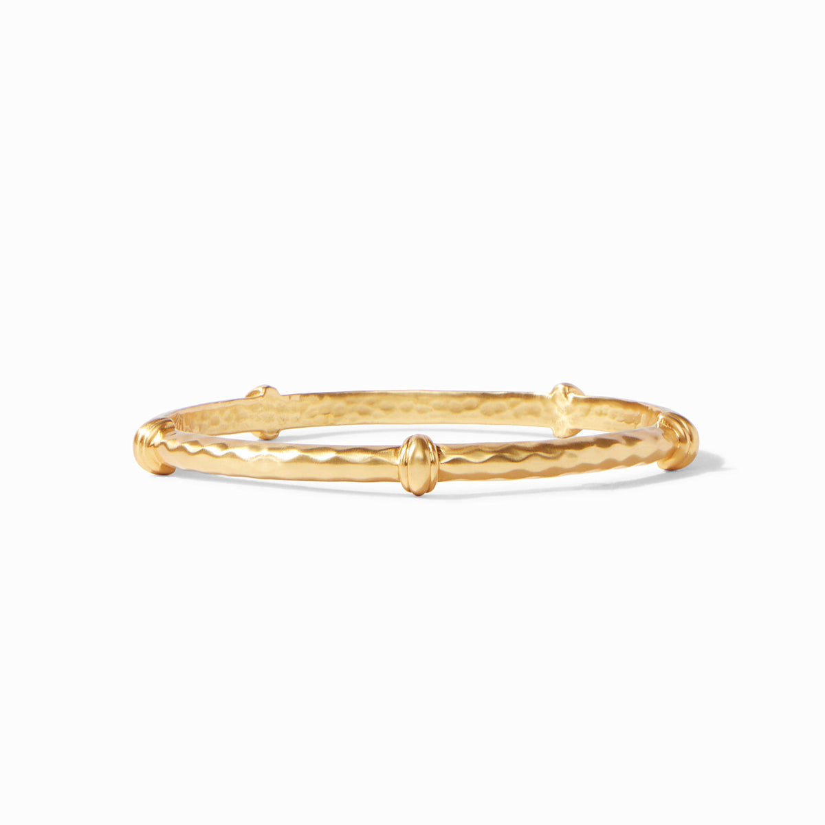 Gold gilded Savannah bangle featuring diamond hammering texture and decorative stations.